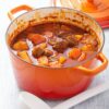 beef stew with potato and carrot in red casserole