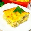 Gratin potato with fish in plate on light board